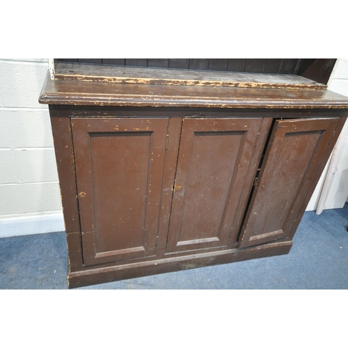 1211 - A 19TH CENTURY PAINTED PINE BOOKCASE, the open shelving top, above a base with triple panelled cupbo... 