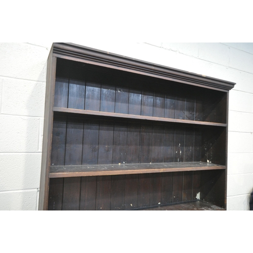 1212 - A 19TH CENTURY PAINTED PINE BOOKCASE, the open shelving top, above a base with triple panelled cupbo... 