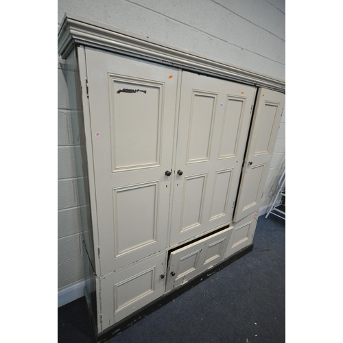 1213 - A 19TH CENTURY PAINTED PINE HOUSEKEEPERS CUPBOARD, with three panelled cupboard doors, enclosing an ... 