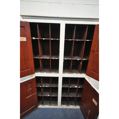 1216 - A 19TH CENTURY PAINTED PINE PANELLED FOUR DOOR CUPBOARD, enclosing an arrangement of pigeons holes, ... 