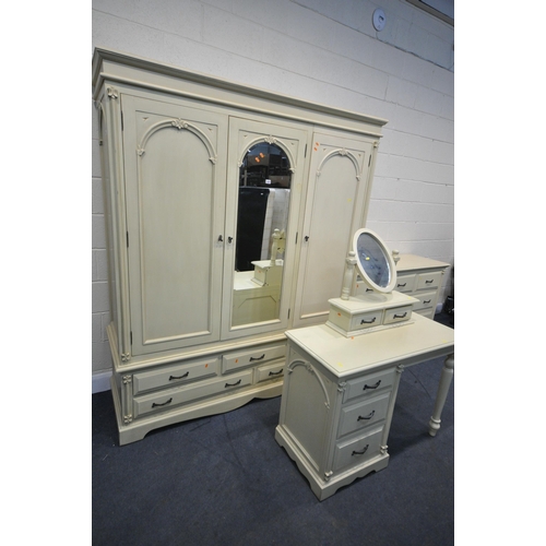 1227 - A GOOD QUALITY CREAM FRENCH BEDROOM SUITE, comprising a triple door wardrobe, above five drawers, wi... 