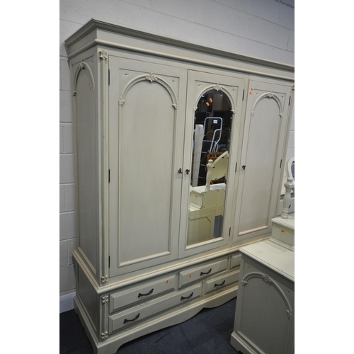 1227 - A GOOD QUALITY CREAM FRENCH BEDROOM SUITE, comprising a triple door wardrobe, above five drawers, wi... 