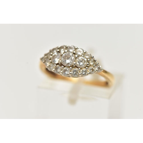 22 - AN 18CT GOLD DIAMOND CLUSTER RING, a navette shaped cluster ring comprised of nineteen round brillia... 