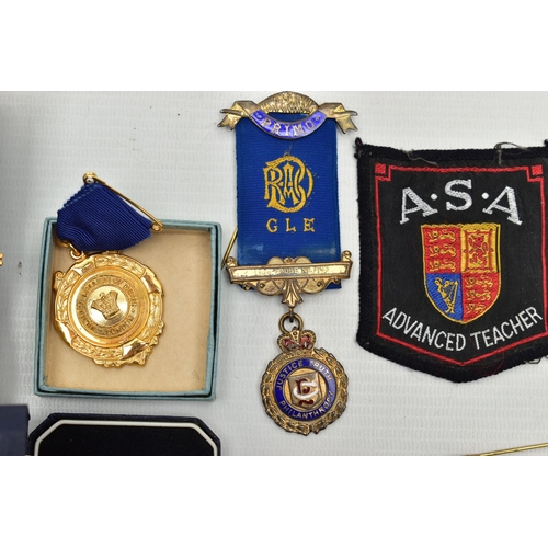 62 - A BOX OF ASSORTED MEDALS, to include two boxed silver and enamel medals for The Swimming Teachers A... 