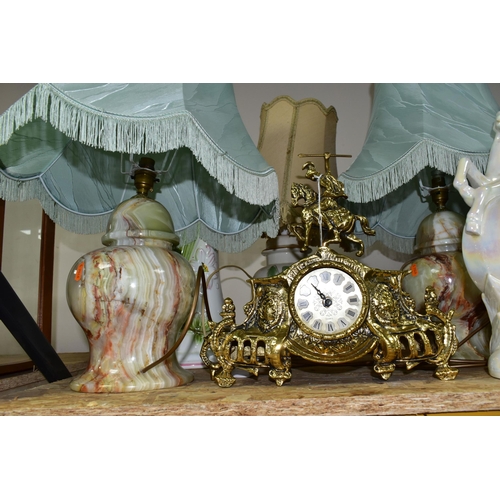 322 - A GROUP OF CLOCKS AND LAMPS, comprising a pair of onyx table lamps with green fringed shades, height... 