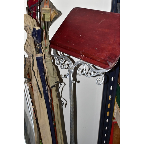 345 - A CAST IRON LECTERN WITH A COLLECTION OF ELEVEN VINTAGE FISHING RODS, comprising Bruce & Walker hand... 