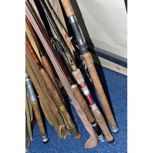 345 - A CAST IRON LECTERN WITH A COLLECTION OF ELEVEN VINTAGE FISHING RODS, comprising Bruce & Walker hand... 