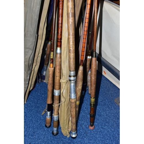 345 - A CAST IRON LECTERN WITH A COLLECTION OF ELEVEN VINTAGE FISHING RODS, comprising Bruce & Walker hand... 