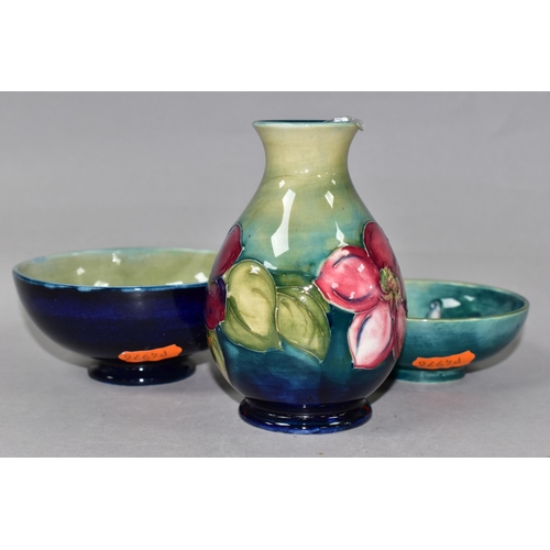 355 - THREE PIECES OF MOORCROFT POTTERY, comprising a Clematis pattern vase height 11cm, a Spring Flowers ... 