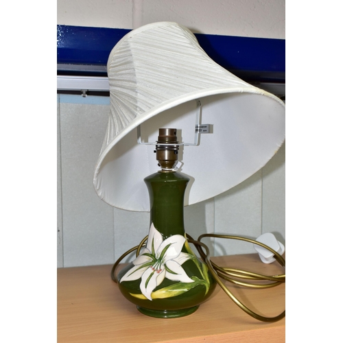 379 - A MOORCROFT POTTERY BERMUDA LILY TABLE LAMP, of compressed baluster form, tube lined with white lily... 