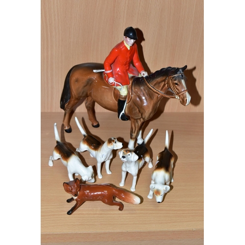 390 - A BESWICK GROUP OF A MOUNTED HUNTSMAN, HOUNDS AND A FOX, comprising Huntsman model no 1501 height 21... 