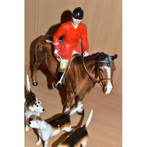 390 - A BESWICK GROUP OF A MOUNTED HUNTSMAN, HOUNDS AND A FOX, comprising Huntsman model no 1501 height 21... 