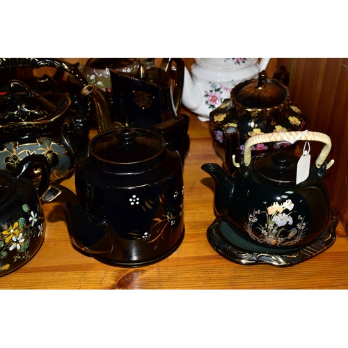 412 - A COLLECTION OF EARLY 20TH CENTURY TEAPOTS, comprising a Sadler hand painted floral design on a blac... 