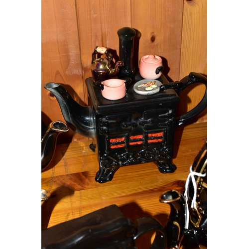 412 - A COLLECTION OF EARLY 20TH CENTURY TEAPOTS, comprising a Sadler hand painted floral design on a blac... 