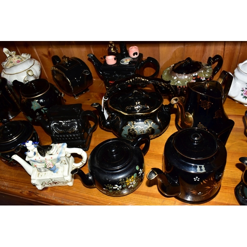 412 - A COLLECTION OF EARLY 20TH CENTURY TEAPOTS, comprising a Sadler hand painted floral design on a blac... 