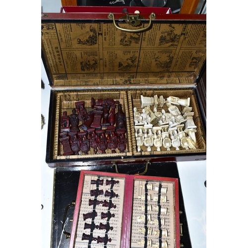 446 - THREE MODERN CHESS SETS, comprising a Chinese travel set in a carry case, a full size Chinese set in... 