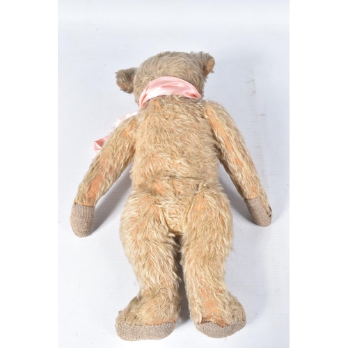 73 - A WELL LOVED GOLDEN PLUSH TEDDY BEAR, original amber and black glass eyes (one loose), remains of ve... 