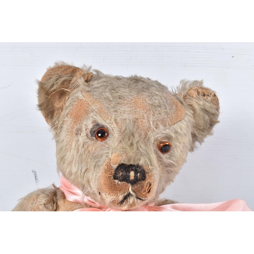 73 - A WELL LOVED GOLDEN PLUSH TEDDY BEAR, original amber and black glass eyes (one loose), remains of ve... 