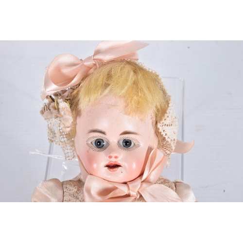 81 - AN UNMARKED GERMAN BISQUE SHOULDER HEAD CHILD DOLL, c.1865 - 1870, fixed blue glass paperweight eyes... 