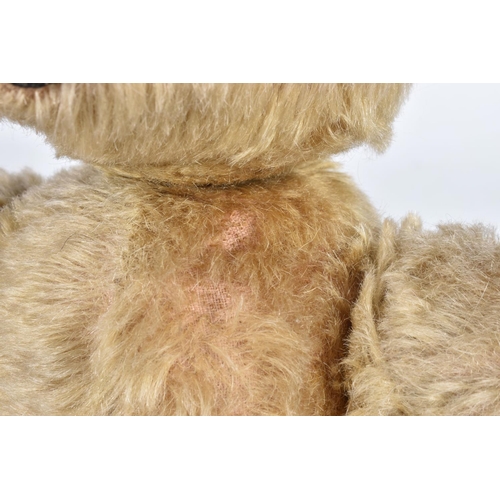 87 - A GERMAN BLONDE MOHAIR TEDDY BEAR, c.1914 - 1920, original glued amber and black glass eyes (both wi... 