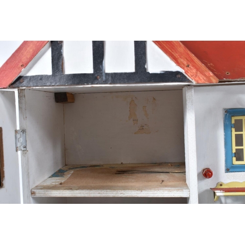 100 - A WOODEN DOLLS HOUSE, c.1950's, modelled as a mock Tudor villa with half-timbered gables, double fro... 