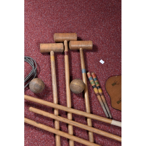 106 - A CROQUET SET, with six wooden mallets, six metal hoops, two wooden pegs and four wooden balls, in p... 