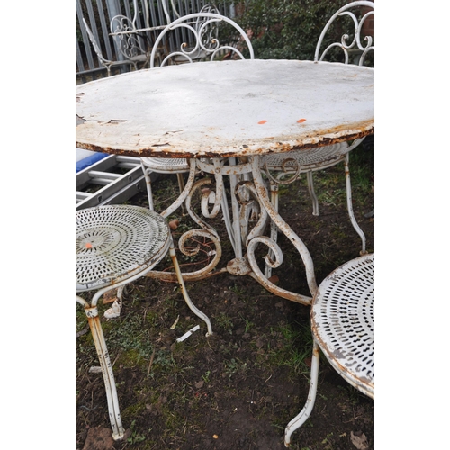 1001 - A WHITE PAINTED METAL GARDEN TABLE 100cm in diameter with scrolled tubular legs and four similar cha... 