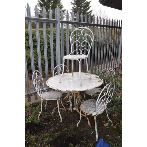 1002 - A WHITE PAINTED METAL GARDEN TABLE 100cm in diameter with scrolled tubular legs and five similar cha... 