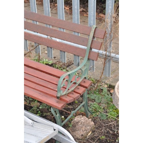 1005 - A WOODEN SLATTED GARDEN BENCH with scrolled cast iron ends, width 122cm