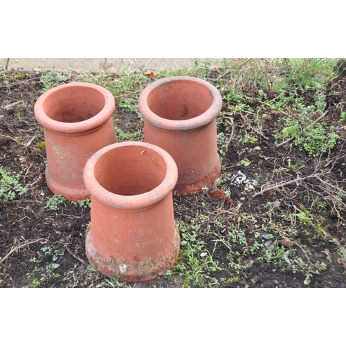 1006 - A COMPOSITE BIRD BATH with tapered square base and round top 50cm high along with three terracotta c... 