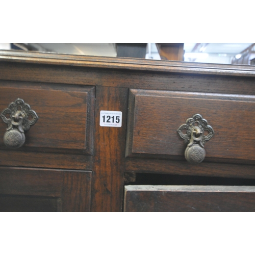 1215 - AN EARLY 20TH CENTURY OAK SIDEBOARD, with two drawers, on barley twist legs, width 121cm x depth 44c... 