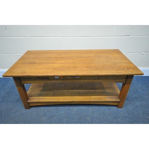 1218 - A GOLDEN OAK COFFEE TABLE, with a single drawer to each side, with undershelf, length 117cm x depth ... 