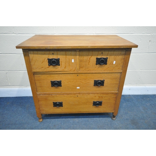 1224 - A COTSWOLD SCHOOL STYLE SOLID OAK CHEST OF TWO SHORT OVER TWO LONG DRAWERS, with circular wrought ir... 