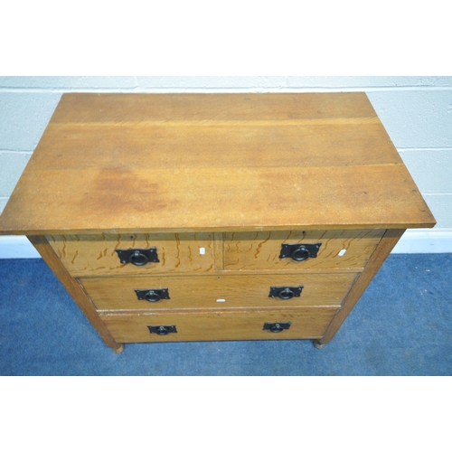 1224 - A COTSWOLD SCHOOL STYLE SOLID OAK CHEST OF TWO SHORT OVER TWO LONG DRAWERS, with circular wrought ir... 