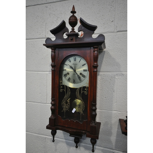 1225 - A MODERN MAHOGANY VIENNA WALL CLOCK with a wavy shaped door, height 88cm, with a winding key and pen... 