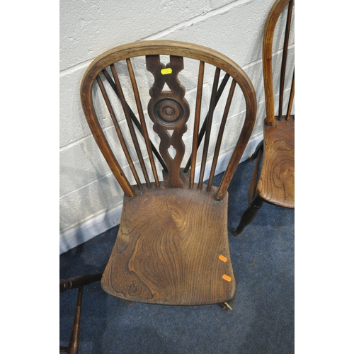 1238 - A SET OF FOUR ELM SPINDLE HOOP BACK CHAIRS, with arched back, united by turned stretchers (condition... 