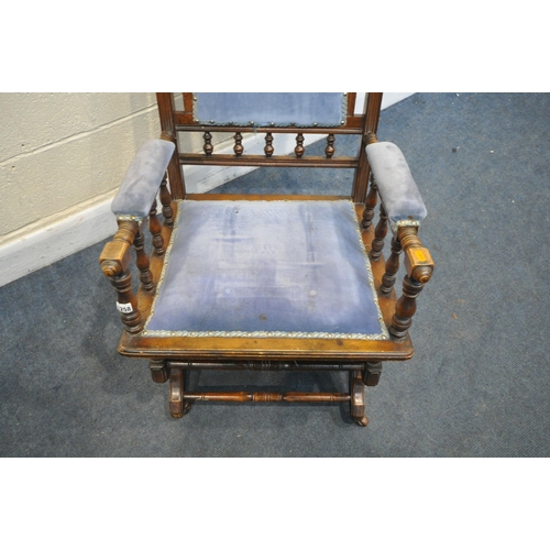 1258 - AN EDWARDIAN WALNUT AMERICAN ROCKING CHAIR (condition:-surface scratches)