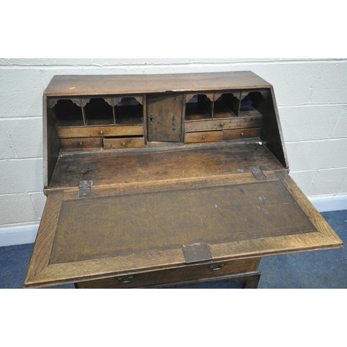 1285 - A GEORGIAN OAK BUREAU, with a fitted interior, on four drawers, and bracket feet, width 91cm x depth... 