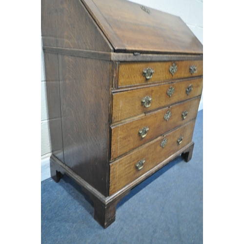 1285 - A GEORGIAN OAK BUREAU, with a fitted interior, on four drawers, and bracket feet, width 91cm x depth... 