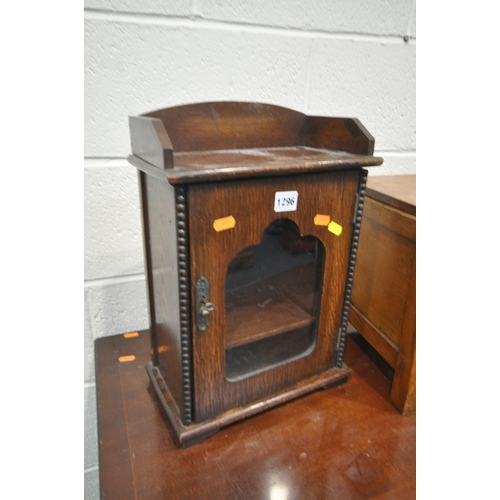 1296 - AN EARLY 20TH CENTURY OAK SMOKERS CABINET, with a fitted interior, and one key, width 29cm x depth 1... 