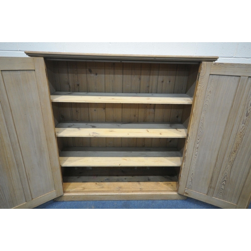 1306 - A 19TH CENTURY PITCH PINE PANELLED DOUBLE DOOR CUPBOARD, enclosing three fixed shelves, width 153cm ... 