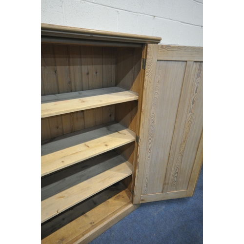 1306 - A 19TH CENTURY PITCH PINE PANELLED DOUBLE DOOR CUPBOARD, enclosing three fixed shelves, width 153cm ... 