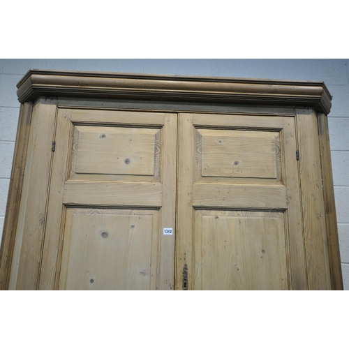 1312 - A LARGE VICTORIAN PINE PANELLED FOUR DOOR CORNER CUPBOARD, enclosing a blue painted interior, and th... 