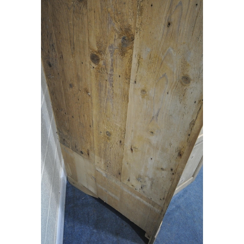 1312 - A LARGE VICTORIAN PINE PANELLED FOUR DOOR CORNER CUPBOARD, enclosing a blue painted interior, and th... 