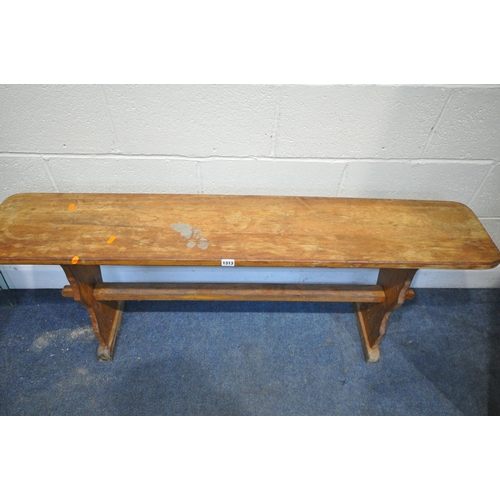 1313 - A BEECH TRESTLE BENCH, with a stretcher, length 134cm x depth 25cm x height 56cm (condition:-worn an... 