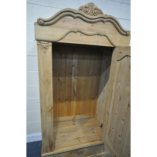 1316 - A FRENCH PINE PANELLED SINGLE DOOR ARMOIRE, with a foliate shaped cornice, and a single drawer, widt... 