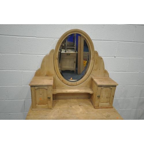 1318 - A PINE DRESSING TABLE, with two panelled cupboards flanking an oval bevelled edge swing mirror, on a... 