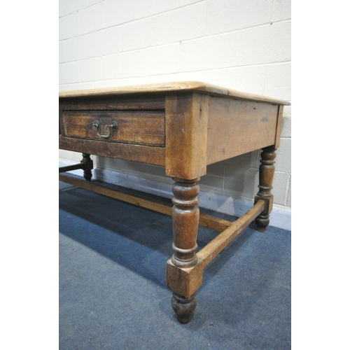 1321 - A LARGE 19TH CENTURY PINE FARMHOUSE TABLE, with three full length frieze drawers, on block and turne... 