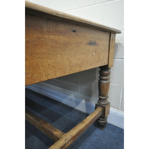 1321 - A LARGE 19TH CENTURY PINE FARMHOUSE TABLE, with three full length frieze drawers, on block and turne... 