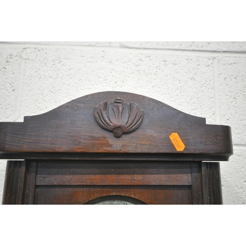 1331 - AN EARLY TO MID 20TH CENTURY OAK WALL CLOCK, with winding key and pendulum (condition - some losses)